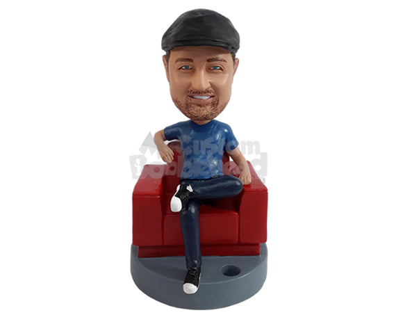 Relaxed guy having a nice day, sitting on the sofa with a pen holder nearby Personalized Bobblehead