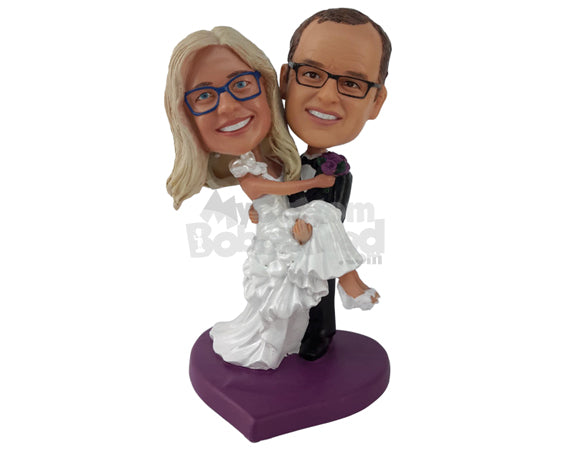 Custom Bobblehead Guy Holding His Wife In His Hands With Both Of Them Dressed Perfectly - Wedding & Couples Bride & Groom Personalized Bobblehead & Cake Topper