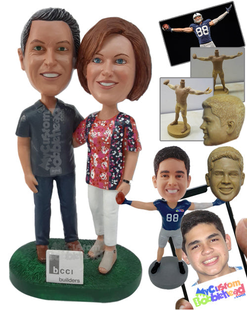 Builder Couple Standing Next to a Board with Hands on Each Other's Shoulders Personalized Bobblehead