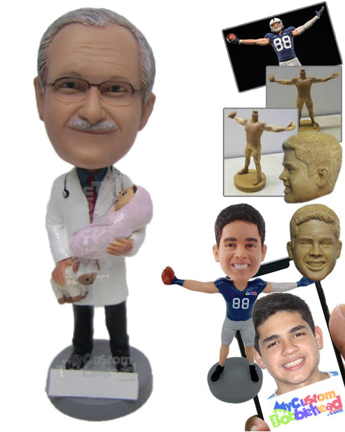 Obyn Gynecologist Male Doctor in Medical Attire Holding a Baby in One Hand and a Teddy Bear in Other Personalized Bobblehead