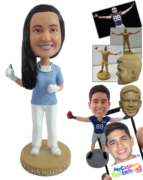 Nice young dentist holding a pulling tool, with a face mask around the neck Personalized Bobblehead