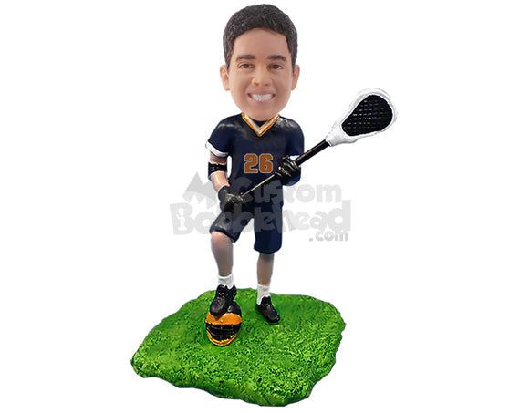 Male lacrosse player having a good time with his uniform on, stepping on his helmet Personalized Bobblehead