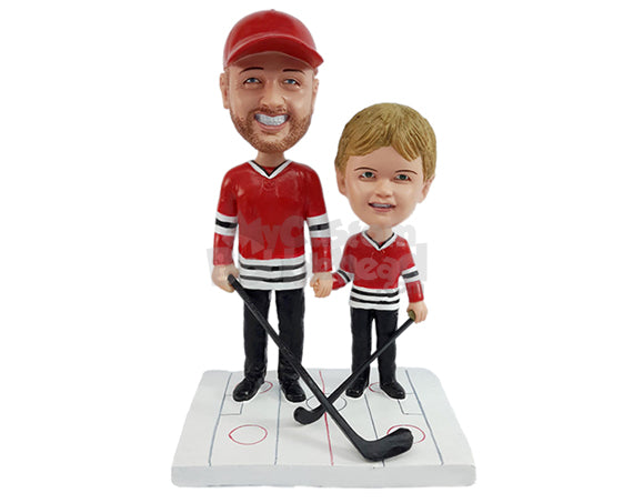 Father and Son Together at a Hockey Game, Wearing Jerseys and Holding Sticks Personalized Bobblehead